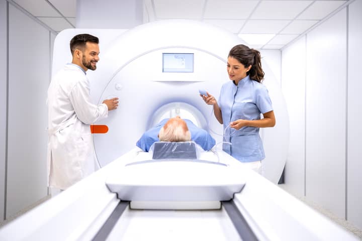 A woman being prepared for an MRI scan